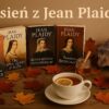 Realistyczna fotografia przedstawiająca książki Jean Plaidy z prawdziwymi okładkami leżące na stole wśród suchych liści. Obok stoi filiżanka parującej herbaty z cytryną i miodem, a pośród dekoracji jesiennych widać małego jeża. Na górze widnieje napis „Jesień z Jean Plaidy”.